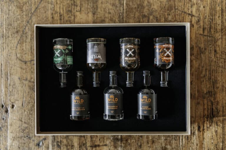 Eine ausgepackte Online Tastingbox mit sieben 5cl Proben.